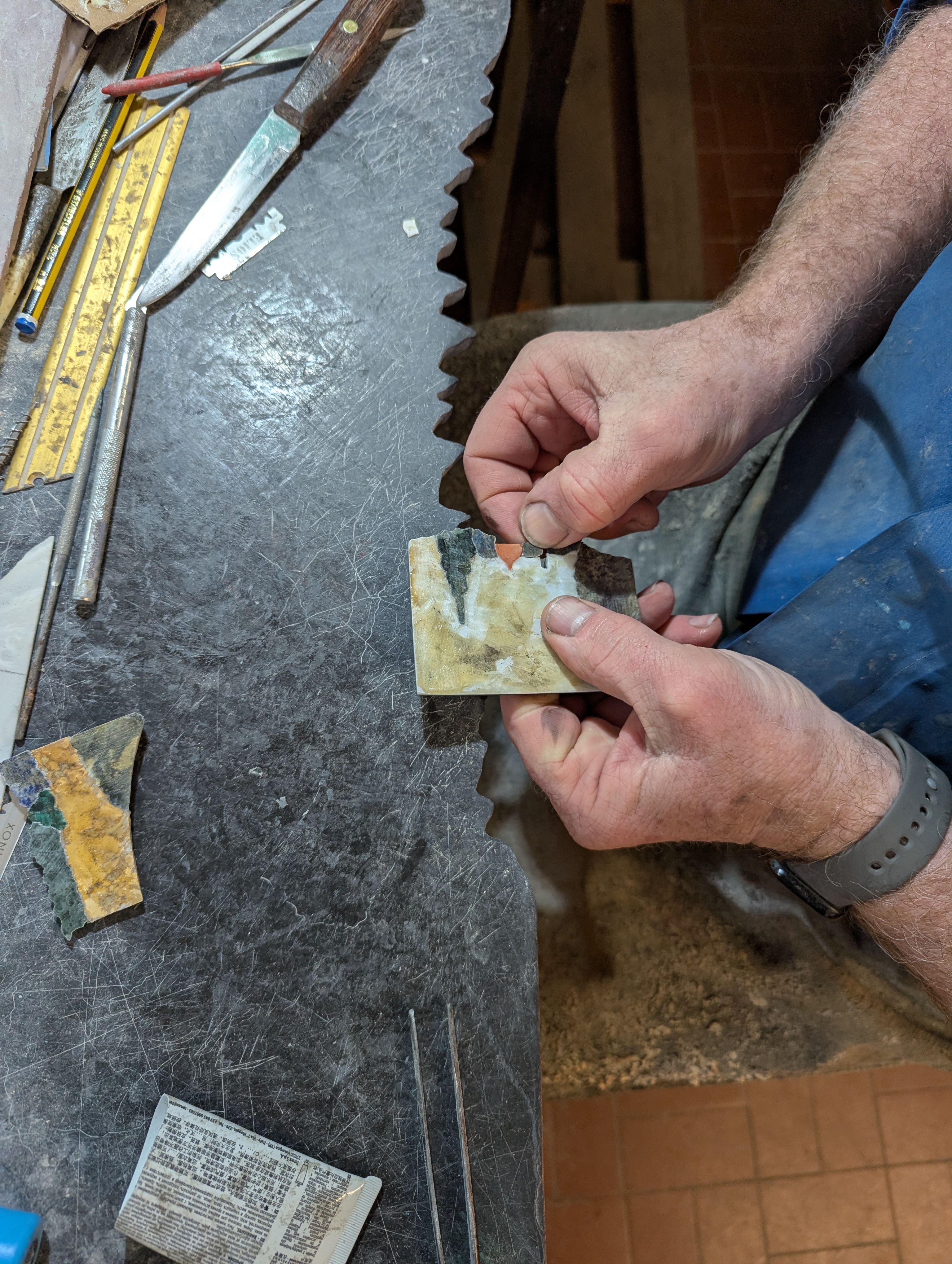 Craftsman's hands working with traditional bow saw